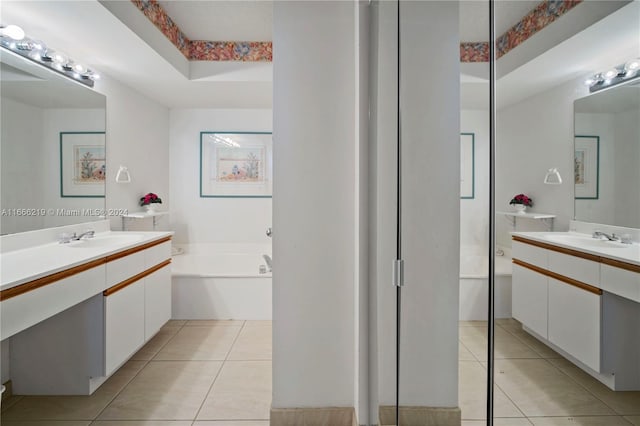 bathroom featuring vanity, a bathing tub, and tile patterned floors