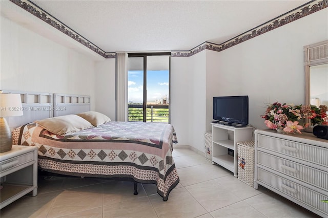 tiled bedroom with access to outside and a textured ceiling