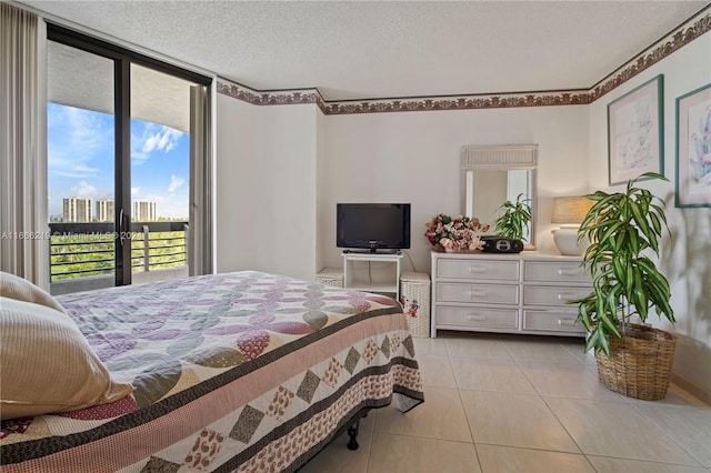 tiled bedroom featuring a textured ceiling and access to exterior