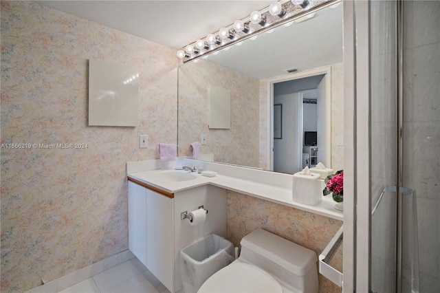 bathroom with tile patterned flooring, walk in shower, vanity, and toilet