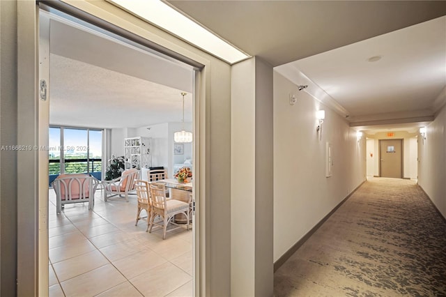 hallway featuring light tile patterned floors and expansive windows