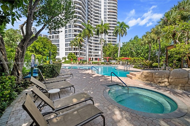 view of swimming pool with a patio and a community hot tub