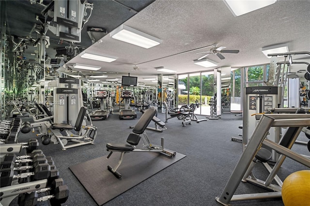 gym featuring a textured ceiling, floor to ceiling windows, and ceiling fan