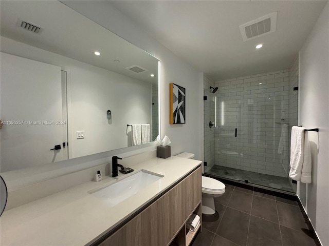 bathroom featuring tile patterned floors, an enclosed shower, vanity, and toilet