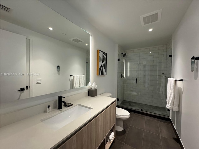 bathroom with tile patterned floors, walk in shower, vanity, and toilet