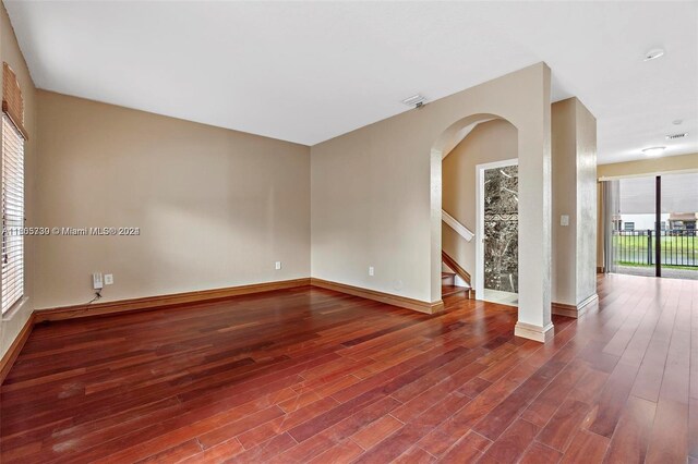 empty room with hardwood / wood-style floors