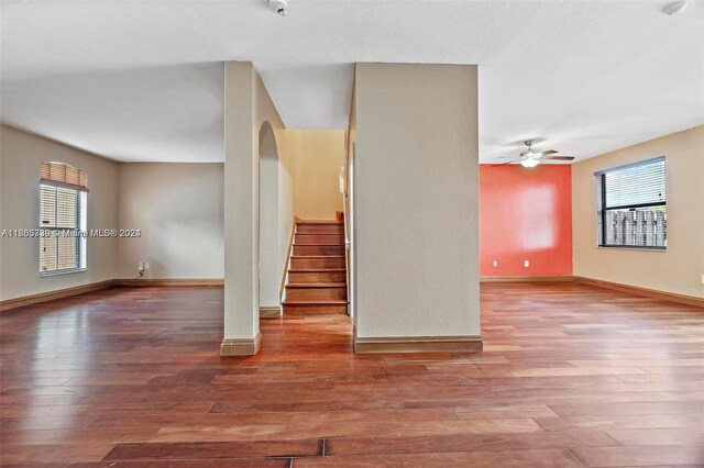 spare room with wood-type flooring, ceiling fan, and a wealth of natural light