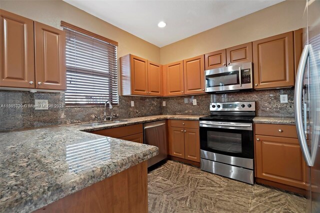 kitchen featuring appliances with stainless steel finishes, sink, and tasteful backsplash