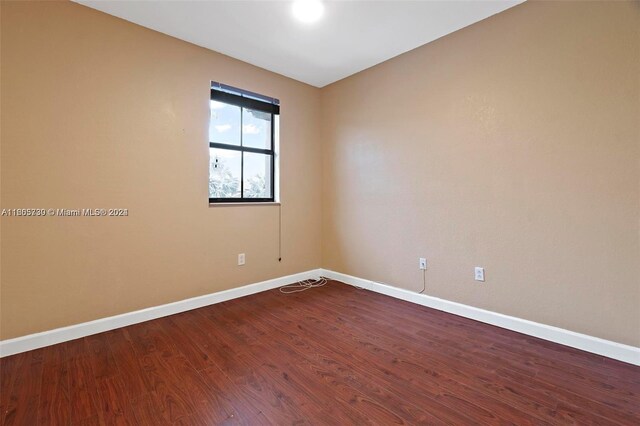 spare room with hardwood / wood-style flooring