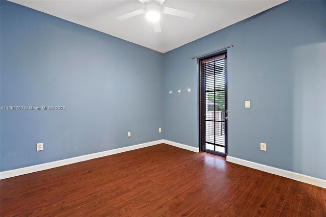 empty room featuring ceiling fan and dark wood-type flooring