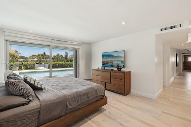 bedroom featuring access to exterior and light wood-type flooring