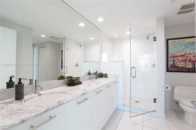 bathroom featuring vanity, an enclosed shower, tile patterned flooring, and toilet