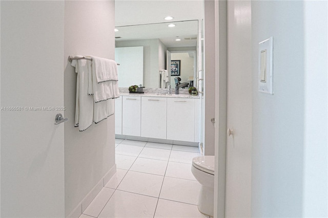 bathroom featuring vanity, toilet, and tile patterned flooring