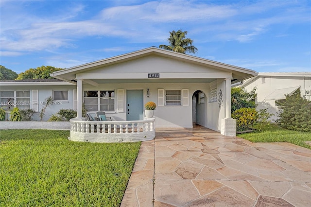 view of front of home featuring a front yard and a porch