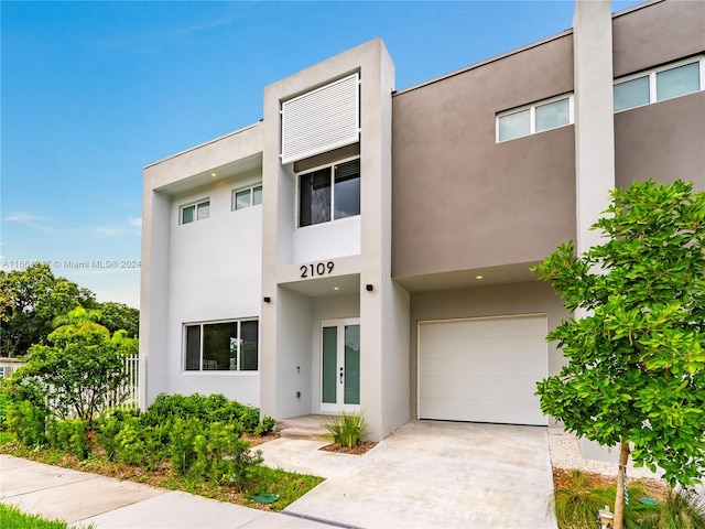 view of front of property featuring a garage and french doors