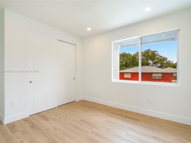 empty room with light hardwood / wood-style flooring