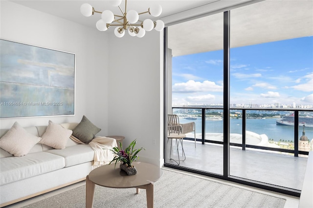 living room with a water view, expansive windows, and a chandelier