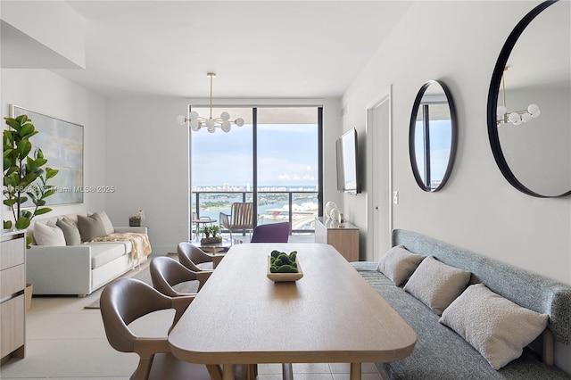 dining space featuring an inviting chandelier and a wall of windows