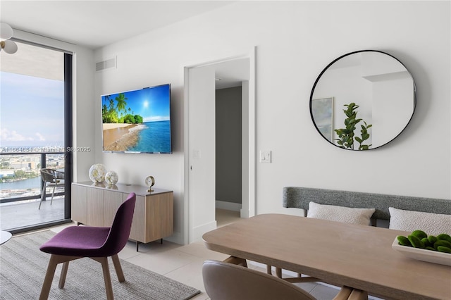 tiled living room featuring expansive windows and plenty of natural light