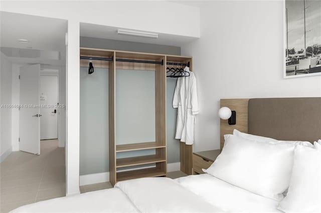 bedroom featuring light tile patterned floors and a closet