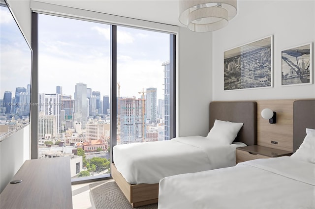 bedroom featuring multiple windows and floor to ceiling windows