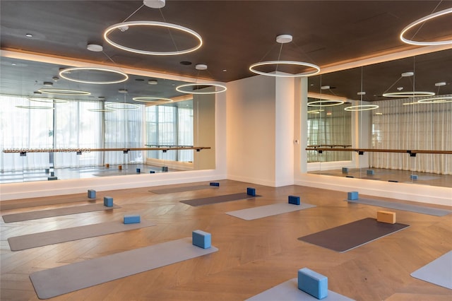 exercise room featuring parquet floors