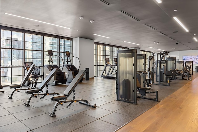 exercise room featuring floor to ceiling windows