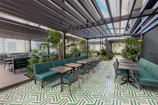 view of patio / terrace with an outdoor living space, exterior bar, and a pergola