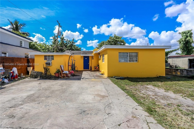 view of front of house with a patio and cooling unit