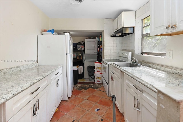 kitchen featuring white cabinets, backsplash, white appliances, light tile patterned floors, and sink