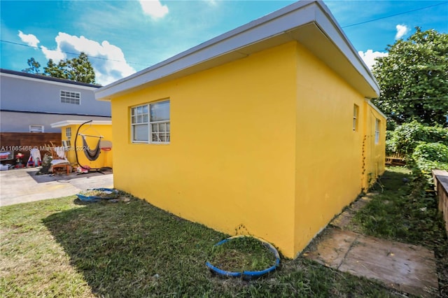 view of property exterior featuring a yard and a patio