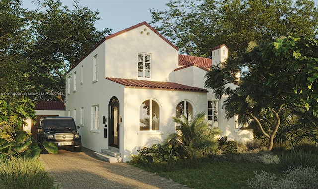 mediterranean / spanish home with a garage