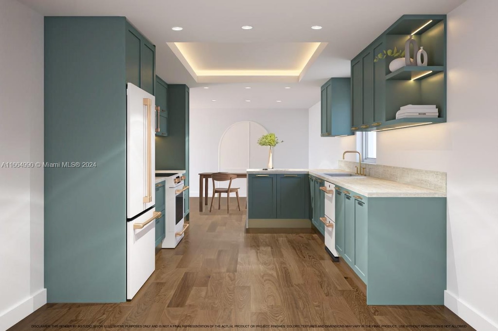 kitchen with white appliances, sink, a raised ceiling, green cabinets, and dark wood-type flooring