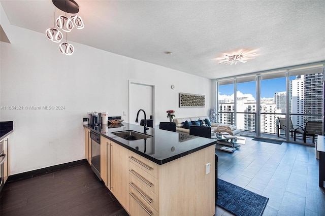 kitchen with dark wood-type flooring, kitchen peninsula, light brown cabinetry, stainless steel dishwasher, and sink