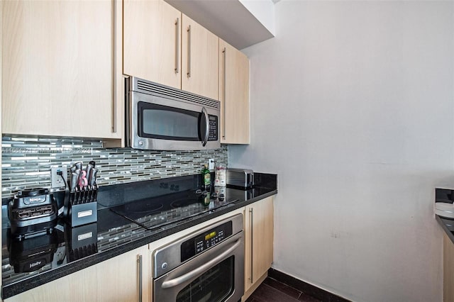 kitchen with backsplash, light brown cabinetry, dark wood-type flooring, and stainless steel appliances