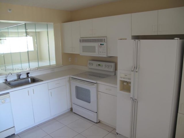 kitchen featuring white cabinets, white appliances, light tile patterned flooring, and sink