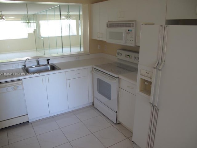 kitchen featuring ceiling fan, light tile patterned floors, sink, white appliances, and white cabinetry