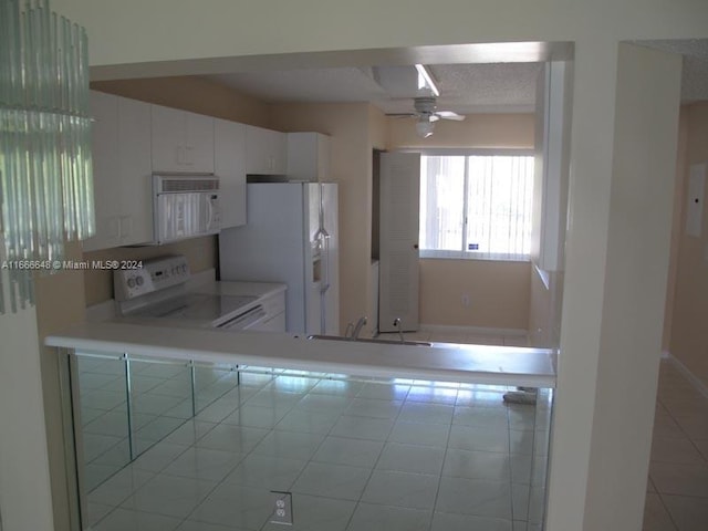 kitchen featuring ceiling fan, light tile patterned flooring, sink, white appliances, and white cabinetry