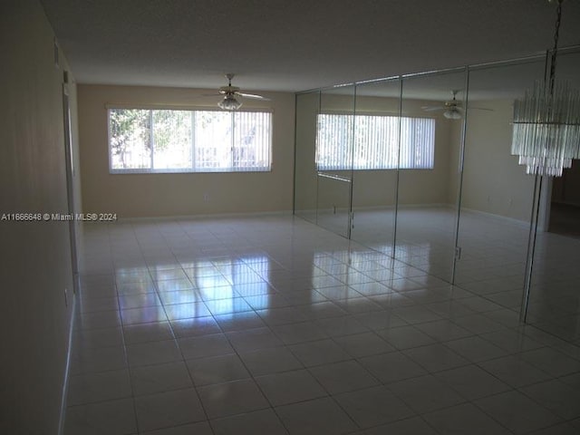 spare room with ceiling fan and tile patterned floors