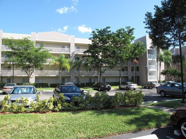 9511 Weldon Cir Unit G215, Tamarac, FL 33321 - view of apartment building / complex with uncovered parking