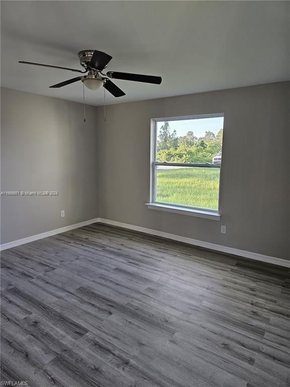 empty room featuring ceiling fan and hardwood / wood-style flooring