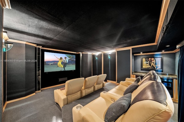 carpeted home theater room with ornamental molding