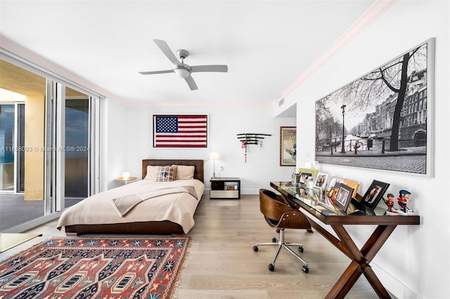 bedroom featuring wood-type flooring, ornamental molding, ceiling fan, and access to exterior