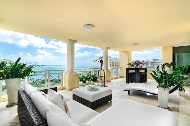 exterior space featuring a water view and outdoor lounge area