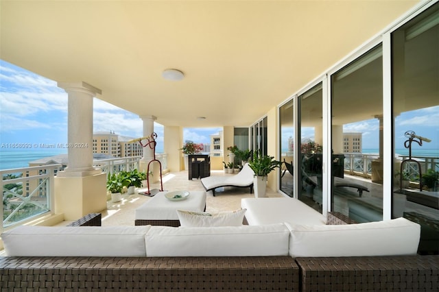 balcony with a water view and an outdoor living space