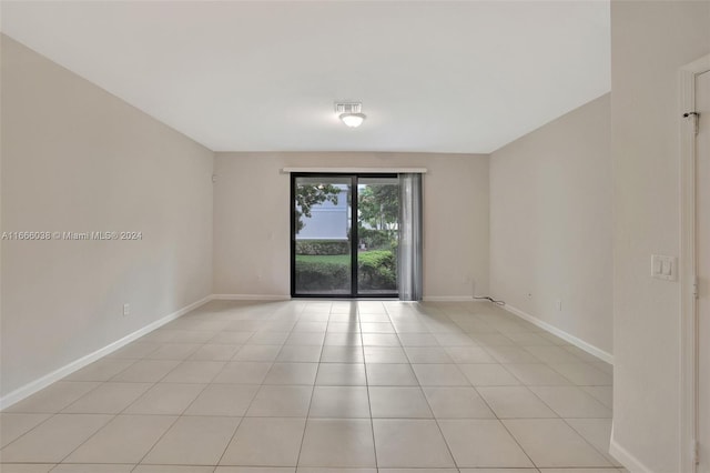 spare room featuring light tile patterned flooring