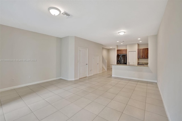 unfurnished living room featuring light tile patterned flooring