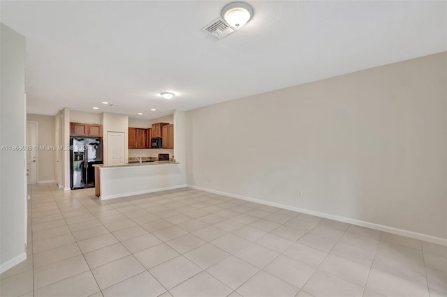 unfurnished living room featuring light tile patterned floors