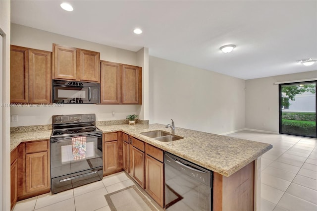 kitchen featuring black appliances, kitchen peninsula, light tile patterned flooring, and sink