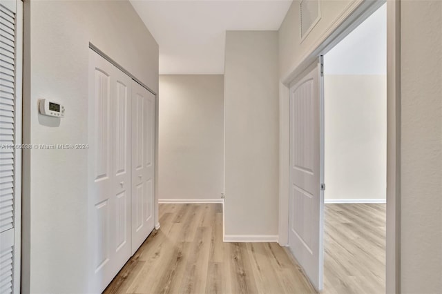 hall with light wood-type flooring